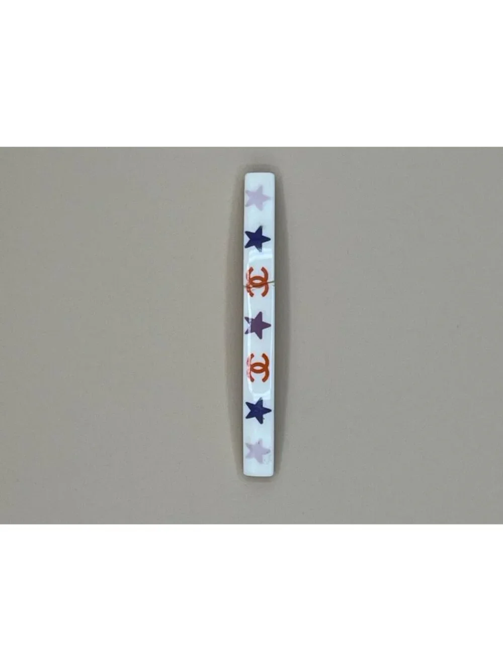 Authentic vintage Chanel bar barrette in cream-white resin, printed with two red
